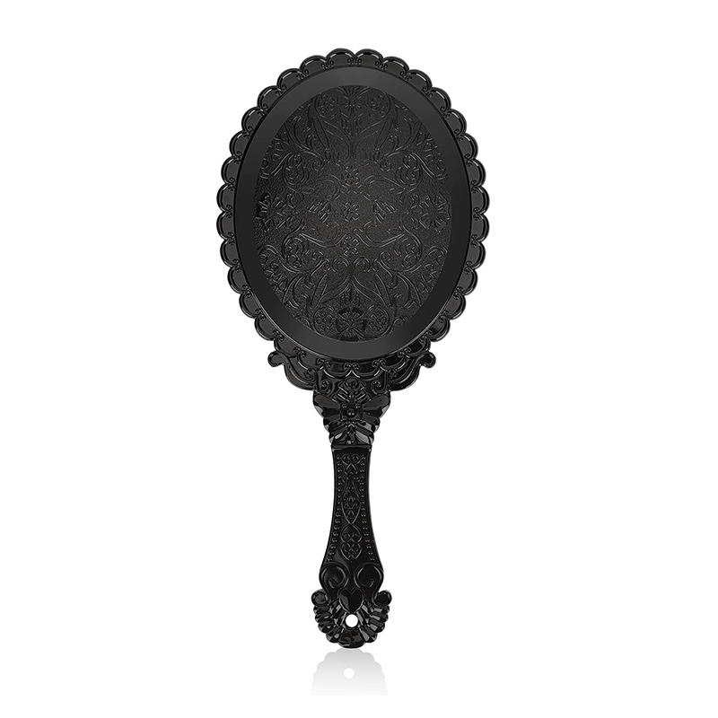Espejo de maquillaje de mano vintage de plástico negro con diseño clásico de flores en relieve