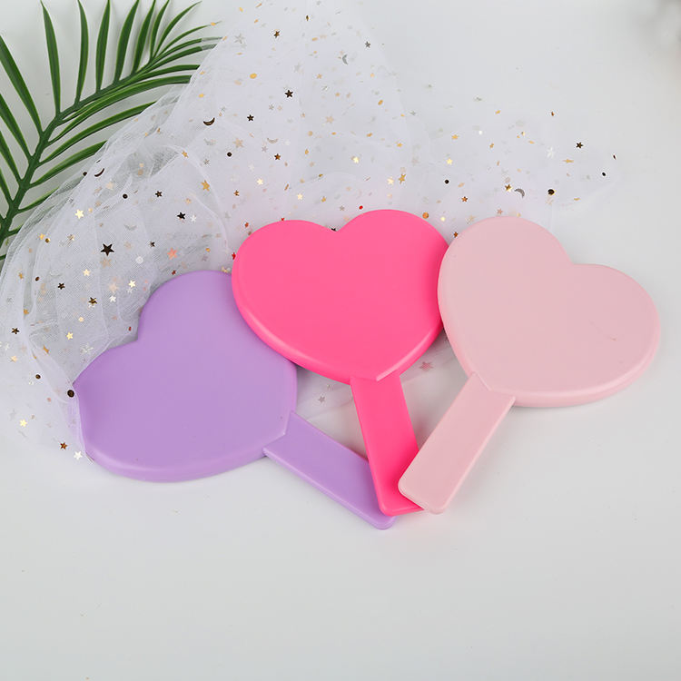 Espejo de vanidad de maquillaje de espejo de mano de plástico con forma de corazón para niñas